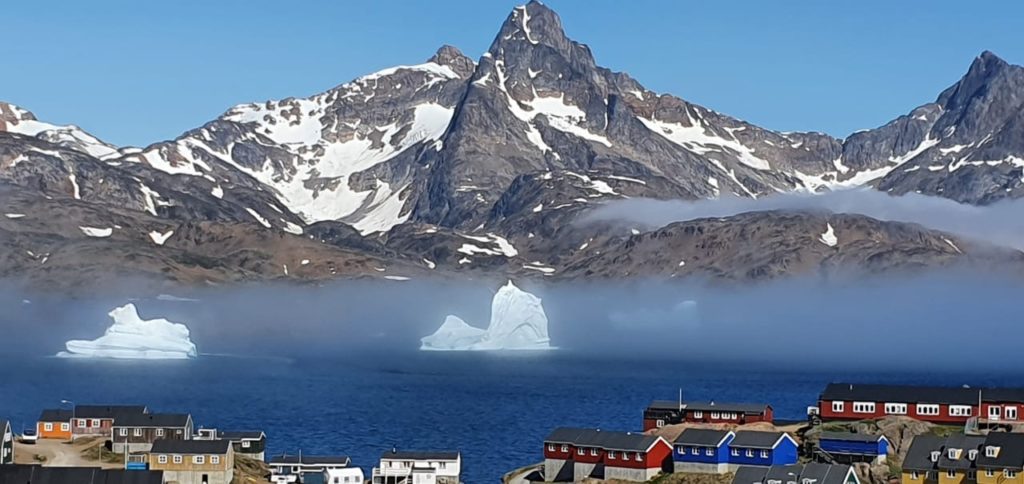 Mountains and sea surrounding a Greeland town