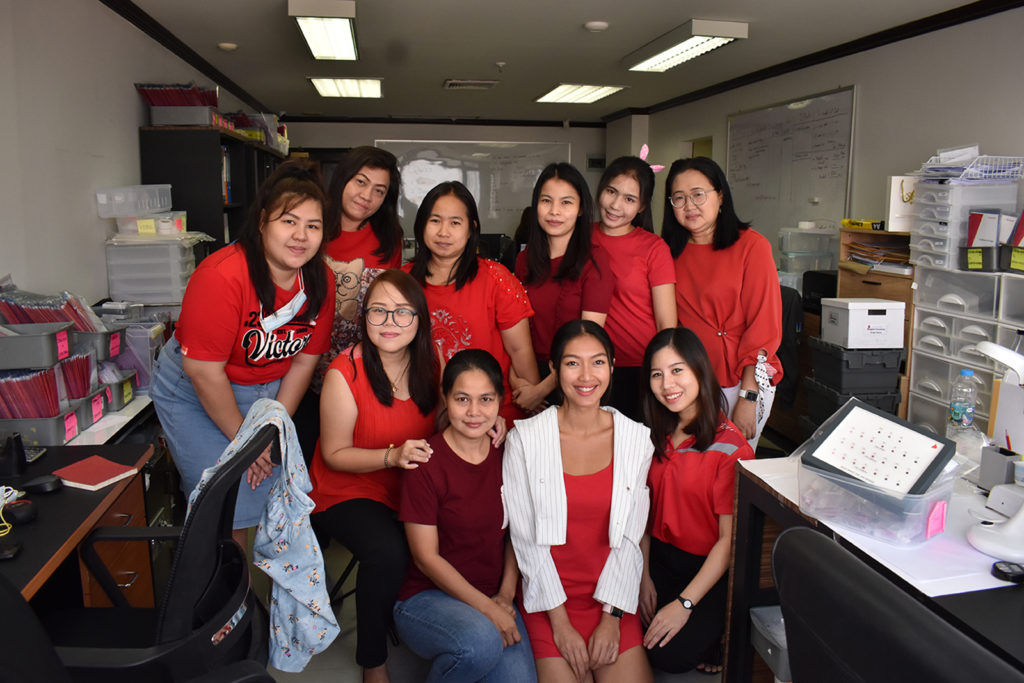 Thai women in a group wearing red
