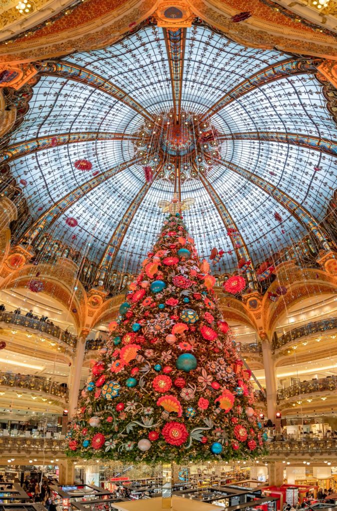 A giant Christmas tree with blue and red ornaments 
