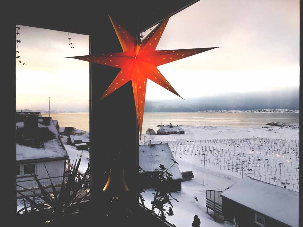 A red star hanging from someone's porch 